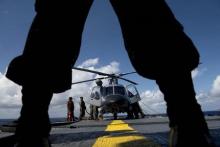 A Philippine Navy personnel stands in front of an Agusta Westland AW109 helicopter before it takes off during Cooperation Afloat Readiness and Training (CARAT) Philippines 2014, a U.S.-Philippines military exercise, aboard Philippine Navy vessel BRP Ramon Alcaraz in the South China Sea near waters claimed by China, June 28, 2014. PHOTO BY REUTERS/Noel Celis