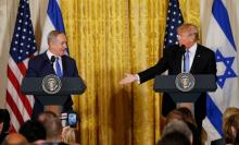 U.S. President Donald Trump (R) reaches to greet Israeli Prime Minister Benjamin Netanyahu after a joint news conference at the White House in Washington, U.S., February 15, 2017. PHOTO BY REUTERS/Kevin Lamarque