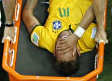 Brazil's Neymar grimaces in pain as he is carried off pitch on a stretcher during their 2014 World Cup quarter-finals against Colombia at the Castelao arena in Fortaleza