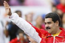 Venezuela's President Nicolas Maduro sings the national anthem during a meeting outside Miraflores Palace in Caracas, November 21, 2014. PHOTO REUTERS/Carlos Garcia Rawlins