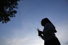 A nun walks to a candlelight vigil in Stone Park, Illinois, June 27, 2014. PHOTO BY REUTERS/Jim Young