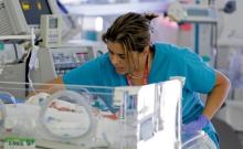 A nurse attends to an infant in the neonatal intensive care unit of the Holtz Children's Hospital at Jackson Memorial Hospital in Miami, September 30, 2013. PHOTO BY REUTERS/Joe Skipper 