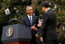 U.S. President Barack Obama (L) shakes hands with Chinese President Xi Jinping as he welcomes him to the White House in Washington, September 25, 2015. PHOTO BY REUTERS/Kevin Lamarque