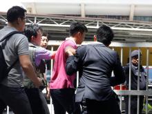 Media journalists scuffle with a North Korean official (in pink) as they try for a door stop at the morgue at Kuala Lumpur General Hospital where Kim Jong Nam's body is held for autopsy in Malaysia, February 15, 2017. PHOTO BY REUTERS/Edgar Su