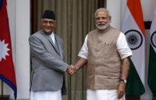 Nepal's Prime Minister Khadga Prasad Sharma Oli (L) shakes hands with his Indian counterpart Narendra Modi during a photo opportunity ahead of their meeting at Hyderabad House in New Delhi, India, February 20, 2016. PHOTO BY REUTERS/Adnan Abidi