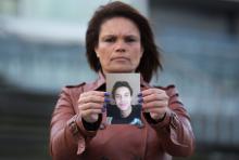 Ozana Rodrigues, the mother of Brian De Mulder, who left for Syria after being indoctrinated by Islamist group Sharia4Belgium, poses with a photo of her son outside the Antwerp courthouse, where the trial of the group is currently taking place, January 29, 2015. PHOTO BY REUTERS/Yves Herman