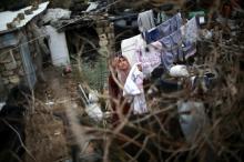 A Palestinian woman hangs laundry on a rope to dry outside her dwelling in Khan Younis in the southern, Gaza Strip. PHOTO BY REUTERS/Ibraheem Abu Mustafa