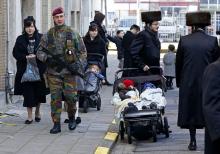 A Belgian paratrooper patrols outside a Jewish school in the central city of Antwerp, January 17, 2015. PHOTO BY REUTERS/Yves Herman