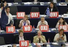 Members of the European Parliament with posters with the word "No" (Oxi) attend a debate on Greece at the European Parliament in Strasbourg, France, July 8, 2015. PHOTO BY REUTERS/Vincent Kessler