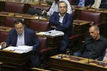 Greek Former Finance Minister Yanis Varoufakis (R), former Deputy Labor Minister Dimitris Stratoulis (C) and former Energy Minister Panagiotis Lafazanis attend a parliamentary session in Athens, Greece, July 22, 2015. PHOTO BY REUTERS/Yiannis Kourtoglou