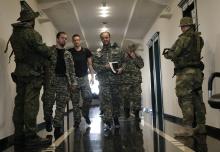 Pavel Gubarev (C, front), one of the leaders of the self-proclaimed Donetsk People's Republic, walks to attend a news conference in the eastern Ukrainian city of Donetsk