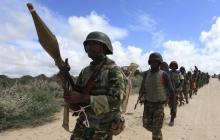 African Union Mission in Somalia (AMISOM) peacekeepers from Burundi patrol after fighting between insurgents and government soldiers erupted on the outskirts of Mogadishu, May 22, 2012. PHOTO BY REUTERS/Feisal Omar