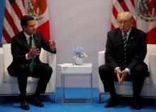 U.S. President Donald Trump speaks with Mexico's President Enrique Pena Nieto during their bilateral meeting at the G20 summit in Hamburg, Germany, July 7, 2017. PHOTO BY REUTERS/Carlos Barria