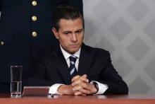 Mexico's President Enrique Pena Nieto sits during a meeting with lawyers in Mexico City, November 21, 2014. PHOTO BY REUTERS/Tomas Bravo
