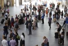 Commuters stop to observe a minute's silence for the victims of the Tunisia terror attack, at King's Cross Station in London, Britain, July 3, 2015. PHOTO BY REUTERS/Peter Nicholls