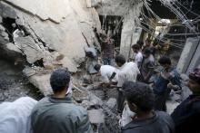People search for survivors under the rubble of the collapsed house of Yemen's late prime minister Faraj Bin Ghanim after it was hit by a Saudi-led air strike in Sanaa, July 2, 2015. PHOTO BY REUTERS/Khaled Abdullah