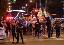 People leave an area taped off by the police near the scene of a mass shooting in Toronto, Canada, July 22, 2018. PHOTO BY REUTERS/Chris Helgren
