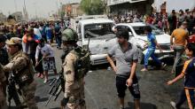 People gather at the scene of a car bomb attack in Baghdad's mainly Shi'ite district of Sadr City, Iraq, May 11, 2016. PHOTO BY REUTERS/Wissm al-Okili