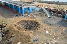 People look at a crater caused by a Saudi-led coalition air strike at the yard of a hospital operated by Medecins Sans Frontieres in the Abs district of Hajja province, Yemen, August 16, 2016. PHOTO BY REUTERS/Abduljabbar Zeyad