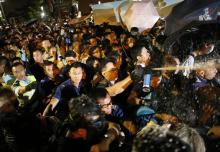 Police use pepper spray as they clash with pro-democracy protesters at an area near the government headquarters building in Hong Kong early
