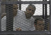 Peter Greste, Mohamed Fahmy and Baher Mohamed (L-R) listen to the ruling at a court in Cairo, June 23, 2014. PHOTO BY REUTERS/Asmaa Waguih