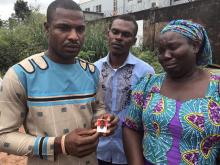 Peter Ujam holds a photograph of his brother, Omyaka Ujam, who he says was killed in an alleged raid at Nnamdi Kanu's home on September 12, 2017, which the army said did not take place, as his sister Philomena Ngene reacts in the city of Umuahia, southeastern Nigeria, September 27, 2017. PHOTO BY REUTERS/Alexis Akwagyiram