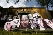 A picture of Saudi blogger Raif Badawi (C) is seen between others photos of prisoners in Saudi Arabia during a demonstration for his release from jail outside the Embassy of Saudi Arabia in Mexico City, February 20, 2015. PHOTO BY REUTERS/Edgard Garrido