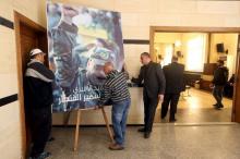 Men place a picture of Lebanese Hezbollah militant leader Samir Qantar, who was killed in an Israeli air strike in Damascus early on Sunday, in Beirut's southern suburbs where his relatives are accepting condolences for his death, December 20, 2015. PHOTO BY REUTERS/Hasan Shaaban