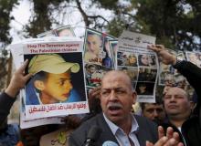 Hussein Abu Khudair (C), father of murdered Palestinian teenager Mohammed Abu Khudair, takes part in a protest outside the Jerusalem District Court, November 30, 2015. PHOTO BY REUTERS/Ammar Awad