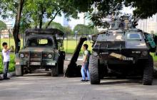 A man use a mobile phone to take pictures of his friend beside an Armoured Personnel Carrier (APC) parked near the venue of the 50th ASEAN Foreign Ministers meeting in Pasay city, metro Manila, Philippines, August 4, 2017. PHOTO BY REUTERS/Romeo Ranoco