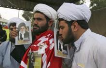 An Iranian Shi'ite Muslim pilgrim (R) kisses a portrait of Iran's Supreme Leader Ayatollah Ali Khamenei while commemorating Arbain in Kerbala, southwest of Baghdad, December 12, 2014. PHOTO BY REUTERS/Mushtaq Muhammed