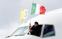 A pilot adjusts an Italian flag on the cockpit window, ahead of Pope Francis' departure for his visit to United Arabs Emirates, at Leonardo da Vinci-Fiumicino Airport in Rome, Italy, February 3, 2019. PHOTO BY REUTERS/Remo Casilli