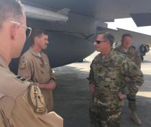 Lieutenant Colonel Jeremy Maestro Renken (C), the U.S. Air Force pilot who shot down an Iranian-made drone over Syria on June 8, 2017, speaks with U.S. Air Force Chief of Staff General David Goldfein next to an F-15E Strike Eagle fighter jet at a U.S. military installation in the Middle East. U.S. PHOTO BY REUTERS/Air Force