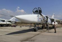 Pilots of a Russian Sukhoi Su-24 fighter jet prepare before a flight at the Hmeymim air base near Latakia, Syria, in this handout photograph released by Russia's Defense Ministry, October 5, 2015. PHOTO BY REUTERS/Ministry of Defence of the Russian Federation