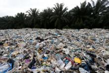 Plastic waste are piled outside an illegal recycling factory in Jenjarom, Kuala Langat, Malaysia, October 14, 2018. PHOTO BY REUTERS/Lai Seng Sin