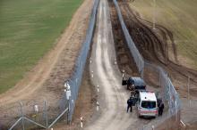 A Hungarian police and soldiers patrol the Hungary-Serbia border, which was recently fortified by a second fence, near the village of Gara, Hungary, March 2, 2017. PHOTO BY REUTERS/Laszlo Balogh