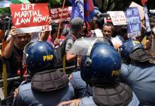 Anti-riot police officers block activists as they protest against the declaration of martial law in Mindanao, southern Philippines, during a rally in front of the Supreme Court in Metro Manila, Philippines July 4, 2017. PHOTO BY REUTERS/Dondi Tawatao