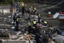 Police remove a barricade left by pro-democracy protesters on a main road leading to the financial Central district in Hong Kong
