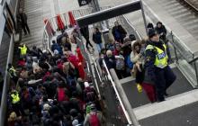 Police organize the line of refugees at on the stairway leading up from the trains arriving from Denmark at the Hyllie train station outside Malmo, Sweden, November 19, 2015. PHOTO BY REUTERS/Johan Nilsson