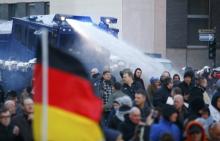 Police use a water cannon during a protest march by supporters of anti-immigration right-wing movement PEGIDA (Patriotic Europeans Against the Islamisation of the West) in Cologne, Germany, January 9, 2016. PHOTO BY REUTERS/Wolfgang Rattay