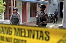 Armed police stand in front a house whose owner was arrested during a raid in the Langgen village in Tegal, Indonesia Central Java, January 15, 2016. PHOTO BY REUTERS/Oky Lukmansyah