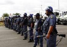 Police officers stand guard to prevent protesters from proceeding with their march in Rustenburg, South Africa's North West Province, September 16, 2012. PHOTO BY REUTERS/Siphiwe Sibeko
