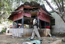 A Somali policeman walks near a small local restaurant attacked by a suicide bomber in Mogadishu, January 2, 2016. PHOTO BY REUTERS/Feisal Omar