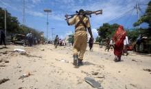 A Somali policeman walks towards the scene of an explosion outside the headquarters of Somalia's Criminal Investigation Department (CID) in the capital Mogadishu, July 31, 2016. PHOTO BY REUTERS/Ismail Taxta