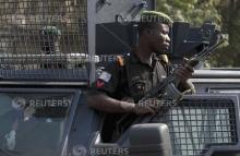 A police officer keeps watch during a protest against the elimination of a popular fuel subsidy that has doubled the price of petrol, in Nigeria's capital Abuja, January 9, 2012. PHOTO BY REUTERS/Afolabi Sotunde