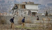 Policemen stand guard near the partially demolished compound where al Qaeda leader Osama bin Laden was killed by U.S. special forces last May, in Abbottabad, February 26, 2012. PHOTO BY REUTERS/Faisal Mahmood