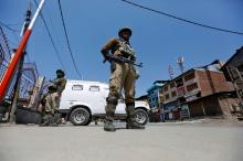 Indian policemen guard a deserted street during restrictions in downtown Srinagar, April 10, 2017. PHOTO BY REUTERS/Danish Ismail