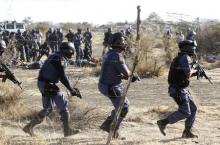 Policemen react after firing shots at protesting miners outside a South African mine in Rustenburg, 100 km (62 miles) northwest of Johannesburg, August 16, 2012. PHOTO BY REUTERS/Siphiwe Sibeko