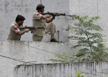 Indian policemen take their positions next to a police station during a gunfight at Dinanagar town in Gurdaspur district of Punjab, India, July 27, 2015. PHOTO BY REUTERS/Munish Sharma