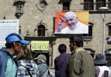 Pedestrians walk at San Francisco square where an image of Pope Francis is displayed in La Paz, June 30, 2015. PHOTO BY REUTERS/David Mercado